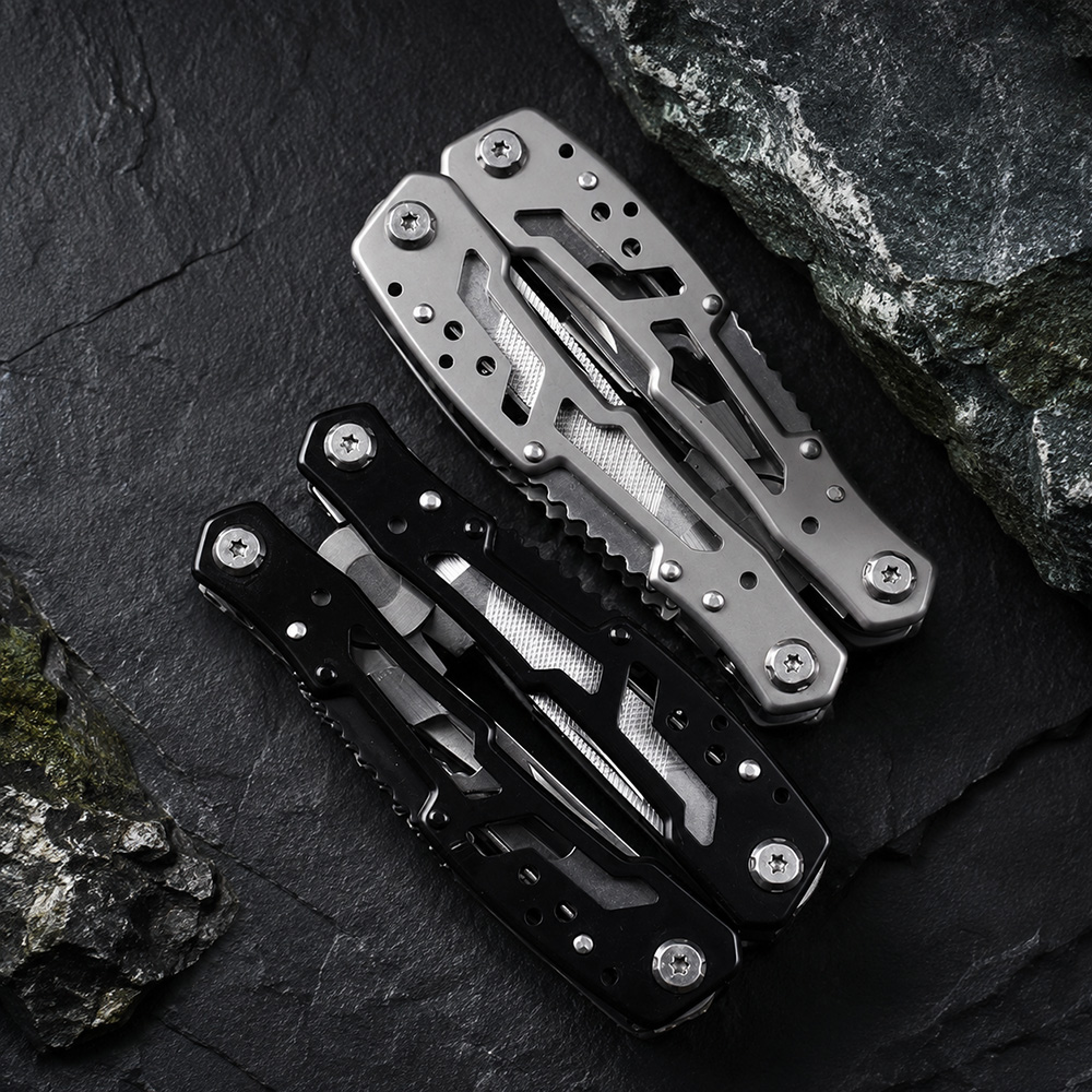 Hand holding stainless steel folding multitool in outdoor setting